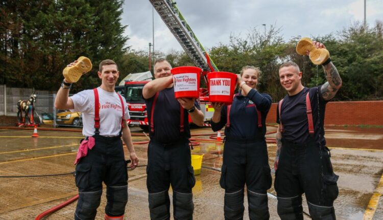 4 fire fighters hold up buckets and sponges