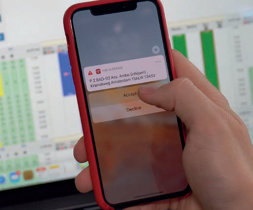 Person's hand holding a mobile phone with a message being displayed on the screen