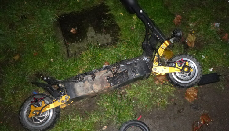 Fire damaged scooter lies on the floor outside