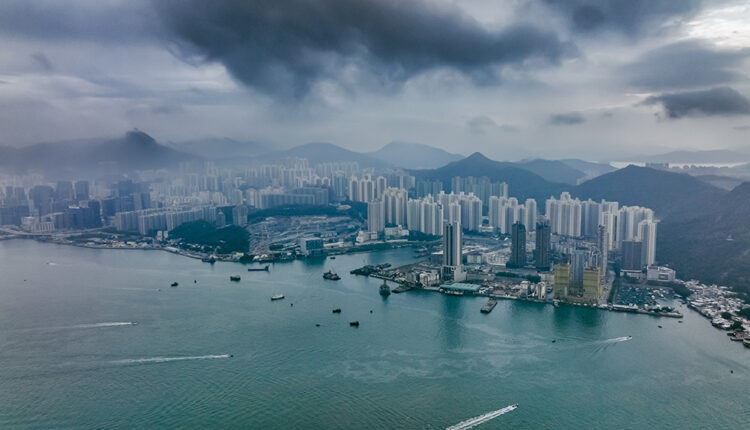 Hong Kongs skyline with towering buildings alongside the water