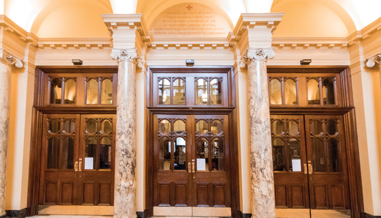 Large wooden doors and marble columns