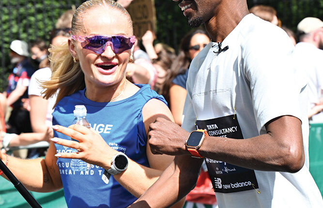 Sir Mo Farah runs alongside Paige Dana Summerton